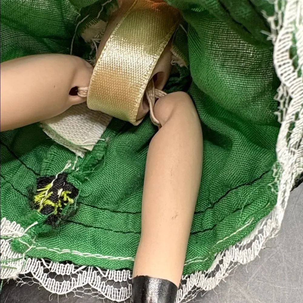 Traditional vintage porcelain doll with Green Hat and Dress